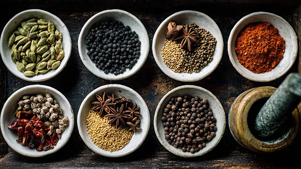 Whole Indian spices in small bowls